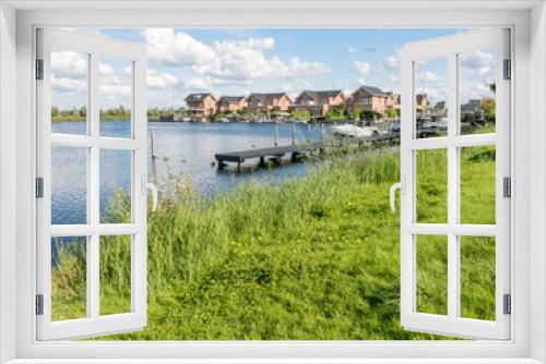 Fototapeta Naklejka Na Ścianę Okno 3D - Waterside houses in green residential suburb, Almere in the province of Flevoland near Amsterdam