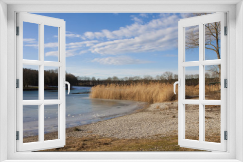 Fototapeta Naklejka Na Ścianę Okno 3D - Winter scene in Bavaria - lake with ice melting on surface