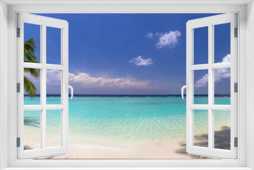 Fototapeta Naklejka Na Ścianę Okno 3D - Idyllic tropical beach panorama with turquoise water, white sand, and palm trees. The image is isolated and peaceful, with no people in sight. Perfect for travel ads and blogs