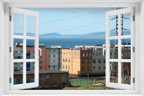 Fototapeta Naklejka Na Ścianę Okno 3D - Apartment building block with hilly tundra coast in background