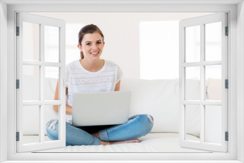 young woman at home using laptop