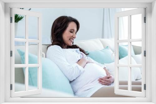 Pregnant woman sitting in the living room