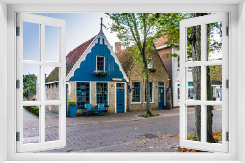 Fototapeta Naklejka Na Ścianę Okno 3D - Houses in Main Street (Dorpsstraat) of East-Vlieland, town on the West Frisian island of Vlieland, Netherlands