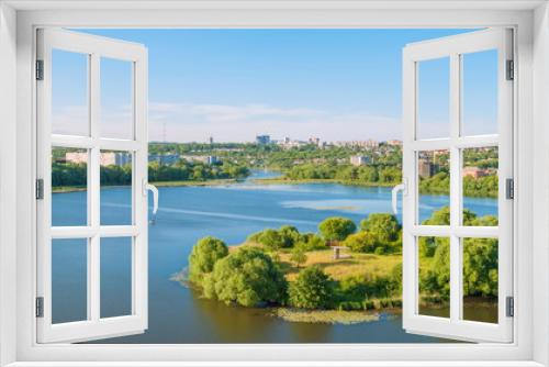 Top view of the river island in the middle of the river and the city on the shore