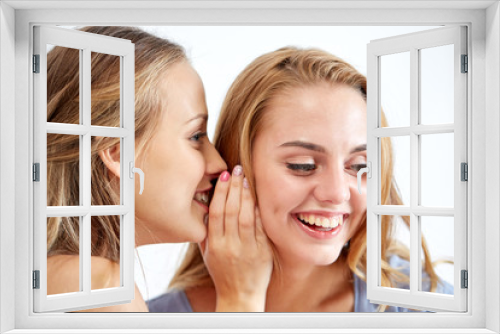 happy young women whispering gossip at home