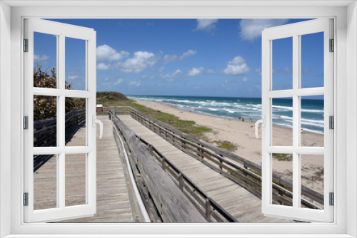 Fototapeta Naklejka Na Ścianę Okno 3D - Old wooden boardwalk provides handicapped access to the beach at John D MacArthur State Park near West Palm Beach, Florida.