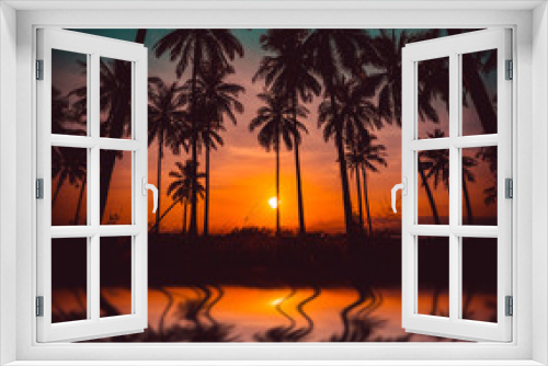 Fototapeta Naklejka Na Ścianę Okno 3D - Silhouette coconut palm trees on beach and reflection at sunset. Vintage tone.
