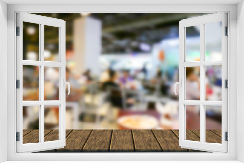 blurry defocused image of people eating food in food court