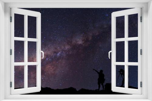 Fototapeta Naklejka Na Ścianę Okno 3D - Star-catcher. A person is standing next to the Milky Way galaxy