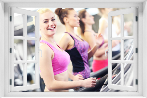 Group of women jogging on treadmill