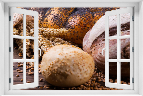 Fototapeta Naklejka Na Ścianę Okno 3D - Assortment of baked bread on wooden table background