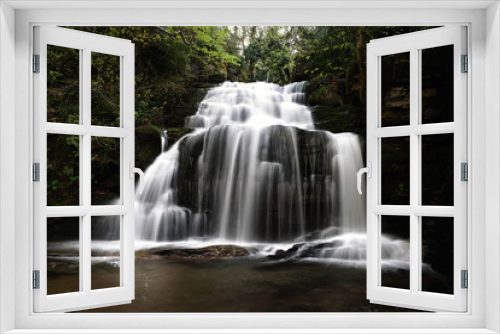 Fototapeta Naklejka Na Ścianę Okno 3D - a big waterfall in forest in spring