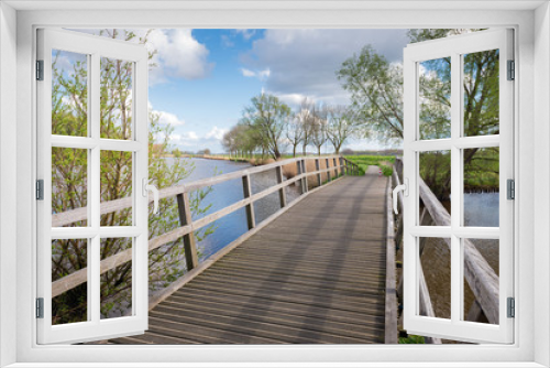 Fototapeta Naklejka Na Ścianę Okno 3D - Wooden bridge on a sunny day in springtime