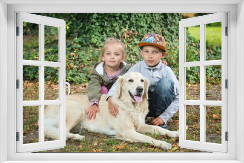 Fototapeta Naklejka Na Ścianę Okno 3D - siblings with a golden retriever