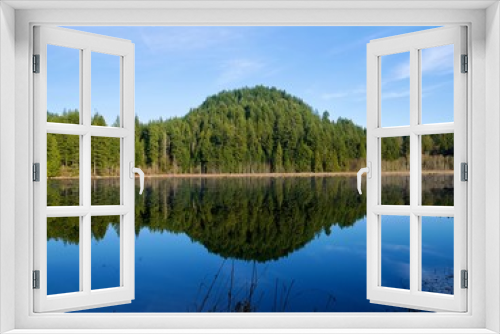 Fototapeta Naklejka Na Ścianę Okno 3D - Green Hills Reflection in Calm Water. Northeast Coquitlam, British Columbia, alongside Pitt-Addington Marsh and the Pitt River. Canada. 