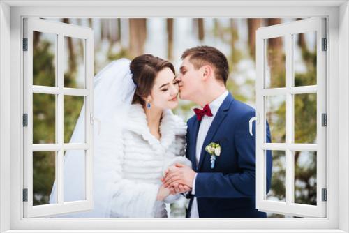 Happy bride and groom in winter day on their wedding