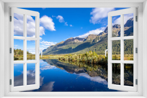 Fototapeta Naklejka Na Ścianę Okno 3D - Reflection of Earl Mountains on the Mirror Lake which is located at the Milford Road,it is one of the New Zealand's great scenic routes.