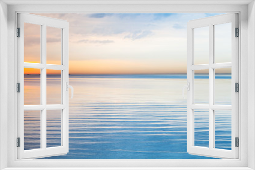 Fototapeta Naklejka Na Ścianę Okno 3D - Still blue sea water under colorful sky