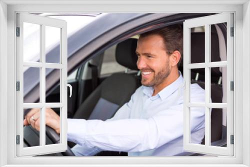 Young attractive man driving his car