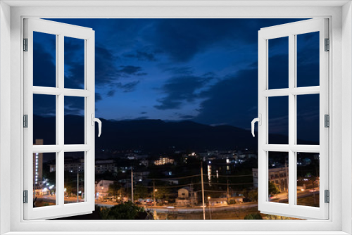 mountain view, cityscape and traffic on road in evening