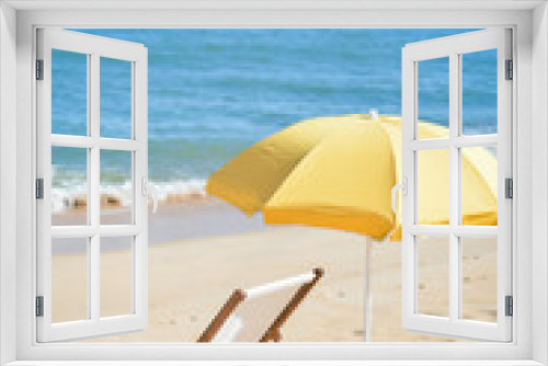Fototapeta Naklejka Na Ścianę Okno 3D - Yellow umbrella and wooden chair on Atlantic sandy beach