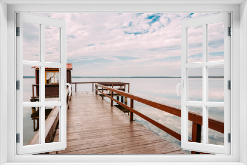 Fototapeta Naklejka Na Ścianę Okno 3D - Old Wooden Pier For Fishing, Small House Or Shed And Beautiful L