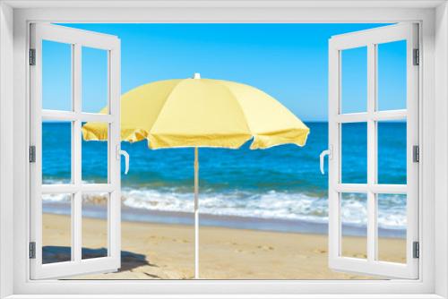 Fototapeta Naklejka Na Ścianę Okno 3D - Yellow parasol on desert ocean beach over blue sky
