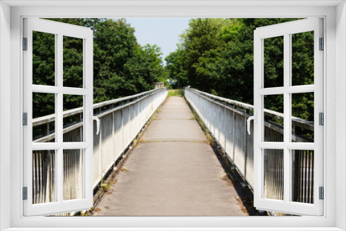 Fototapeta Naklejka Na Ścianę Okno 3D - View along a long footbridge with railings on either side