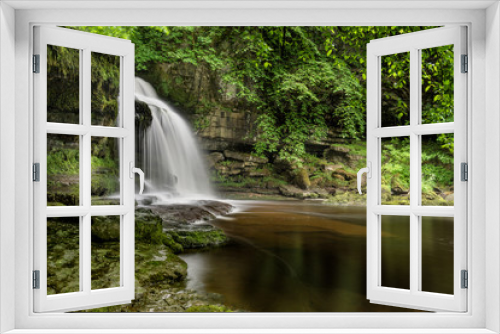 Fototapeta Naklejka Na Ścianę Okno 3D - Peaceful remote waterfall in a woodland forest in the Yorkshire Dales, UK.