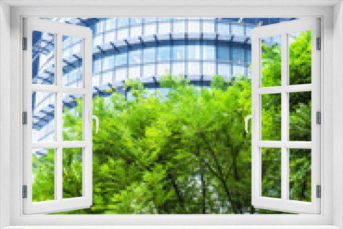 Fototapeta Naklejka Na Ścianę Okno 3D - modern office building with green trees