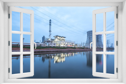 Fototapeta Naklejka Na Ścianę Okno 3D - modern power station near river at twilight