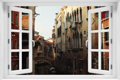 Fototapeta Naklejka Na Ścianę Okno 3D - Evening in Venice. Small canal and houses. Aged photo. Street buildings. Toned image. Channels of Venice. Retro filter photo. Italy.