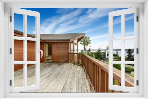 Fototapeta Naklejka Na Ścianę Okno 3D - American house with wooden walkout deck overlooking backyard