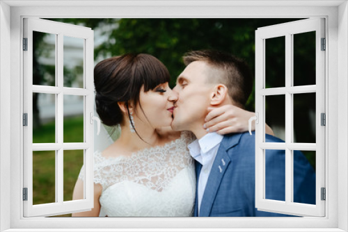 Bride and groom at wedding Day walking Outdoors on summer nature. Bridal couple, Happy Newlywed woman and man embracing. Loving wedding couple outdoor.