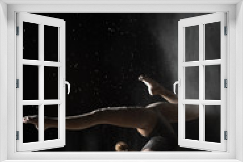 Fototapeta Naklejka Na Ścianę Okno 3D - Gymnastic woman handstand on equilibr while sprinkled flour