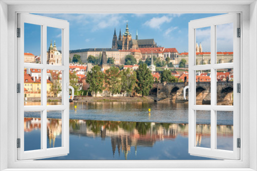 View over river Vltava and Charles bridge to Prague castle with copy space in clear sky