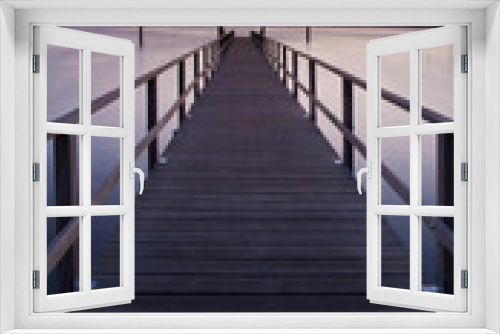 Fototapeta Naklejka Na Ścianę Okno 3D - Wooden Pier into a Lake at Sunset, perfect symmetry