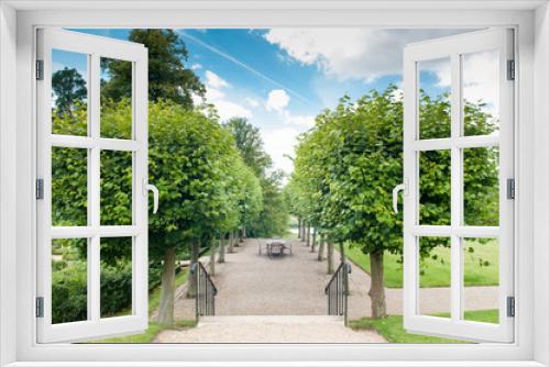 Fototapeta Naklejka Na Ścianę Okno 3D - Formal garden entrance with shaped hedges and trees