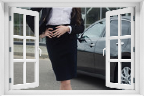 Business woman standing in the street background car