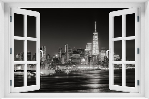 Fototapeta Naklejka Na Ścianę Okno 3D - Skyscrapers of New York City Financial District illuminated at night. Aerial panoramic view of Lower Manhattan and the Hudson River in Black & White