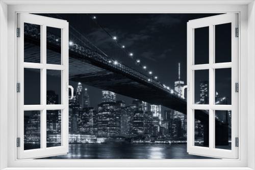 Fototapeta Naklejka Na Ścianę Okno 3D - The downtown Manhattan skyline and the Brooklyn Bridge at night