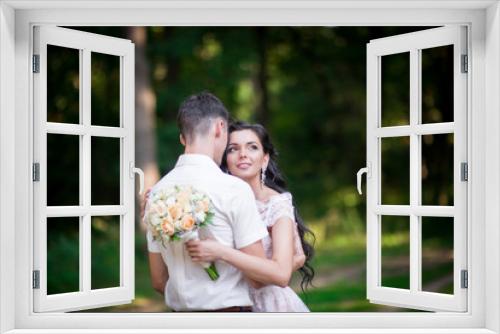 Beautiful luxury newlyweds posing outside