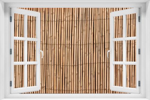 Fototapeta Naklejka Na Ścianę Okno 3D - The texture of the dry reeds.  A fence made of reeds.