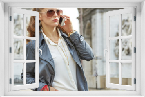 fashion-monger near Arc de Triomphe in Paris using mobile phone