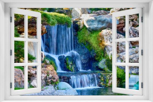 Fototapeta Naklejka Na Ścianę Okno 3D - A small waterfall in a garden