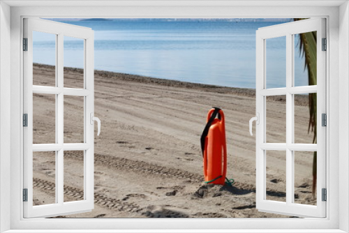 Fototapeta Naklejka Na Ścianę Okno 3D - Lifeguard float stuck in the sand