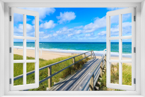 Fototapeta Naklejka Na Ścianę Okno 3D - Wooden footbridge from sand dune to beautiful beach near Westerland village, Sylt island, Germany