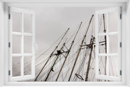 Fototapeta Naklejka Na Ścianę Okno 3D - Fishing boat masts against cloudy sky background