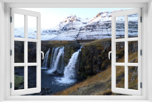 Fototapeta Naklejka Na Ścianę Okno 3D - Kirkjufellsfoss waterfall and the snow capped mountain in the morning sunlight, Snaefellsness Peninsula of Iceland