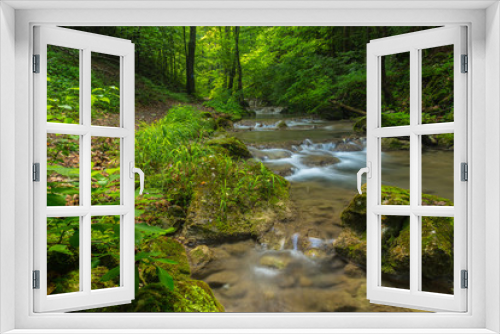 Fototapeta Naklejka Na Ścianę Okno 3D - Pristine waterfalls deep in the woods, on a bright sunny day in spring